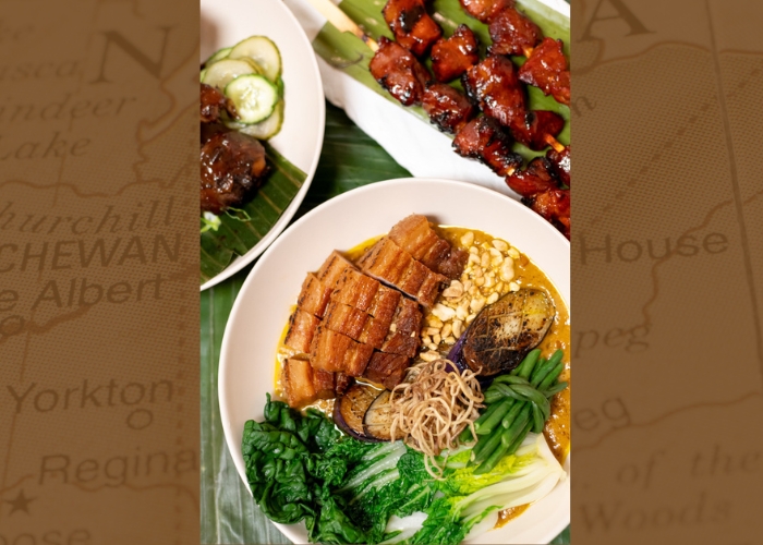Various plates with Filipino dishes like kare-kare and barbecue.
